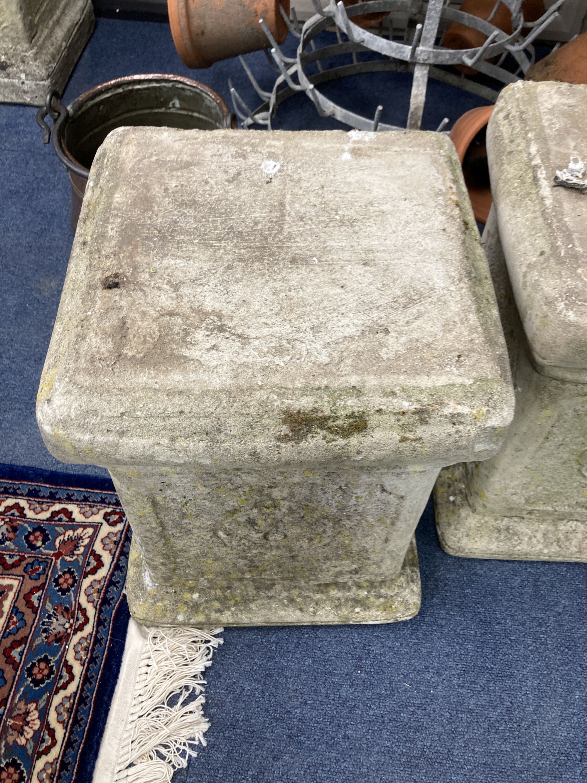 A pair of reconstituted stone plinths, height 39cm